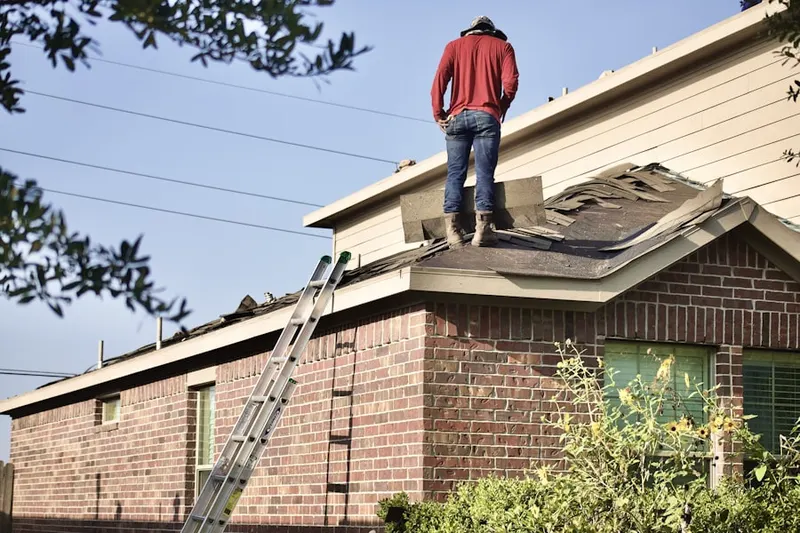 Professional roofer working on a residential roof in Musser